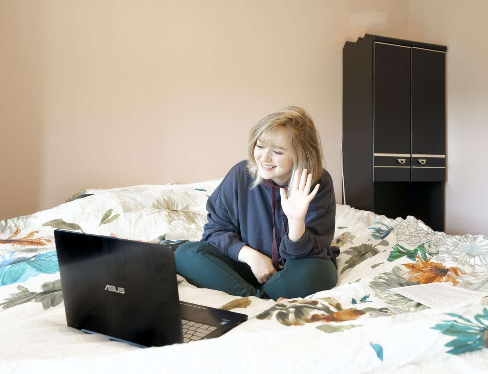 Woman Sitting on Bed with Laptop