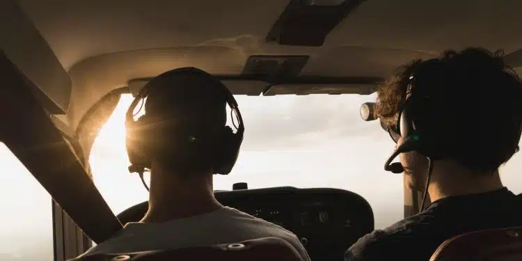 closeup photo of two pilot and co pilot inside plane